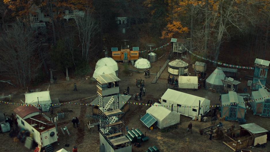 Aerial shot of the camp sitting beneath the mansion.