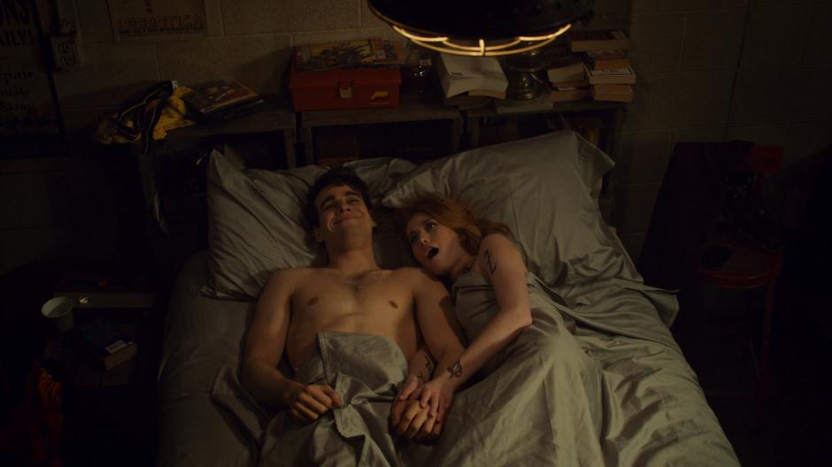 Simon and Clary lie in bed in the morning.