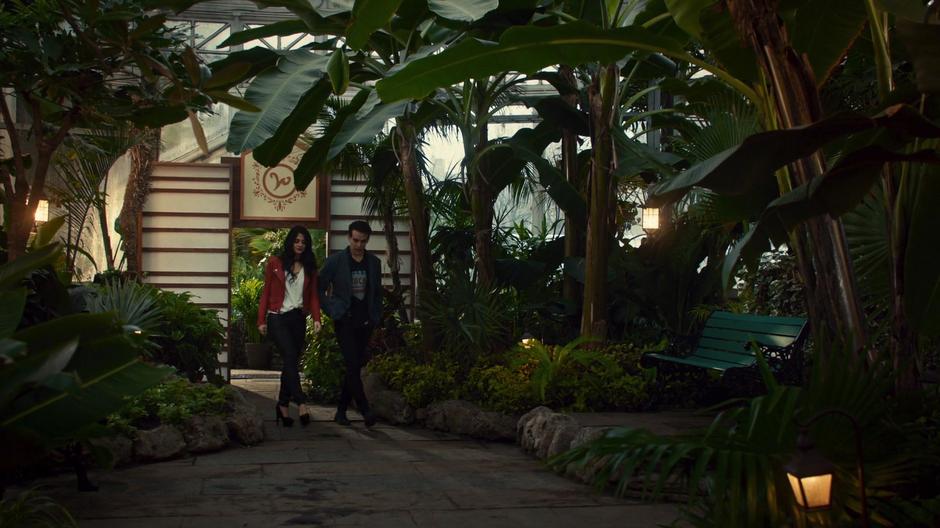 Izzy and Simon walk through the greenhouse.