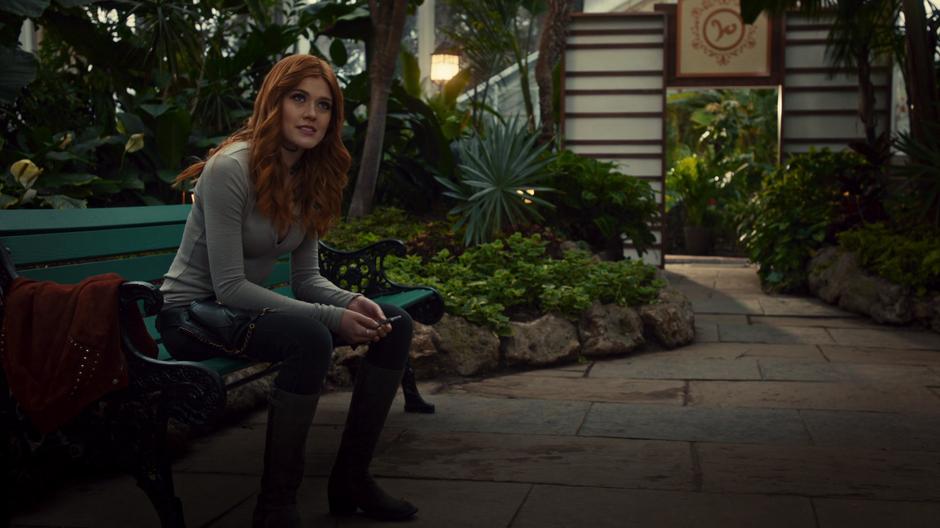 Clary listens to Sebastian's compliment while sitting on the bench.