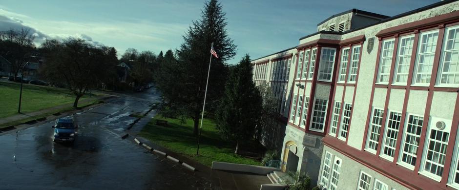 Sam drives up to the front of the school with Jason.