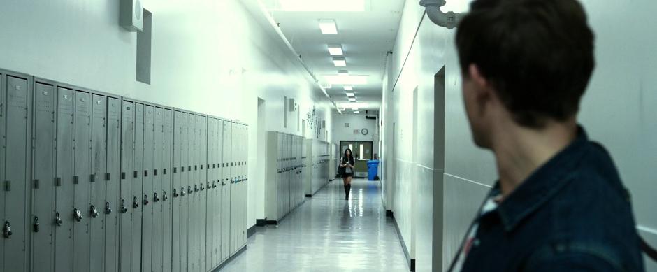 Jason watches Kimberly walk down the hall.