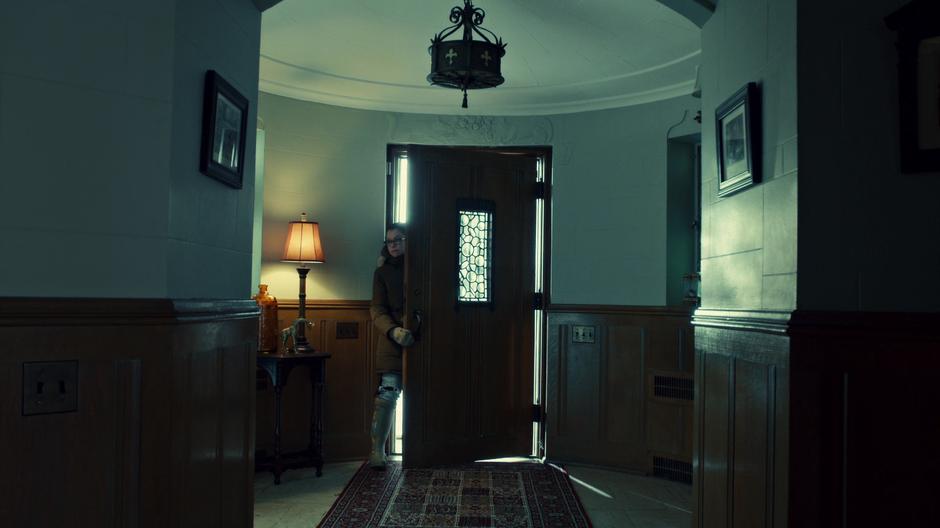 Cosima enters through the front door of the house for her meeting with P.T. Westmoreland.