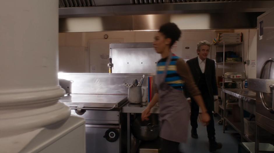 The Doctor follows Bill around the kitchen.