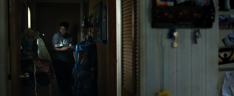 Zack emerges from his mother's bedroom with a tray full of dirty dishes.