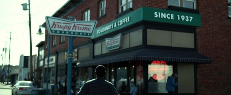 Billy walks towards Krispy Kreme after realizing that is the location of the Zeo Crystal is under the store.