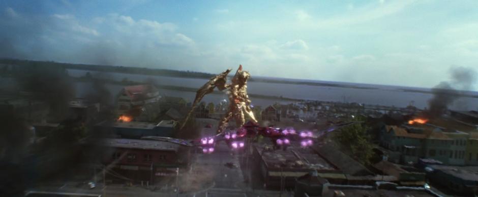 Kimberly flies the pink Zord towards Goldar who is approaching the store.