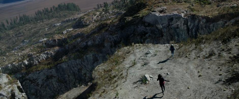 Trini races towards a chasm above the mine while Kimberly chases after her.