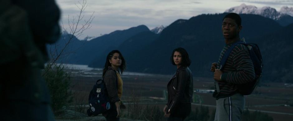 Trini, Kimberly, and Billy look back at Zack when he proposes camping out together for the night.