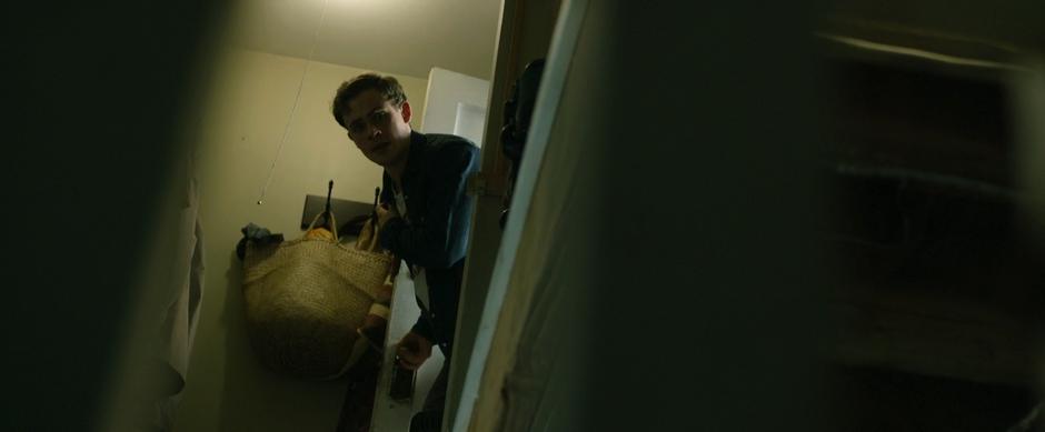 Jason peaks his head around the corner at the top of the basement stairs and calls out for Billy.