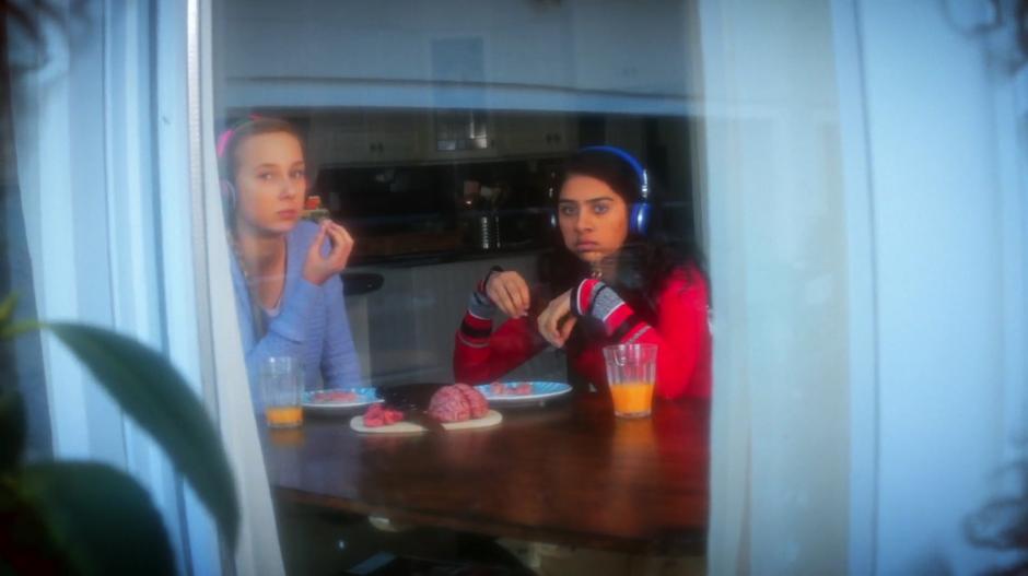 Tatum and Patrice spot Katty Kupps outside the window in a vision while they sit at the kitchen table eating brains.