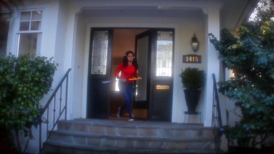 Patrice Gold exits the house from the front door in the vision carrying a weapon.