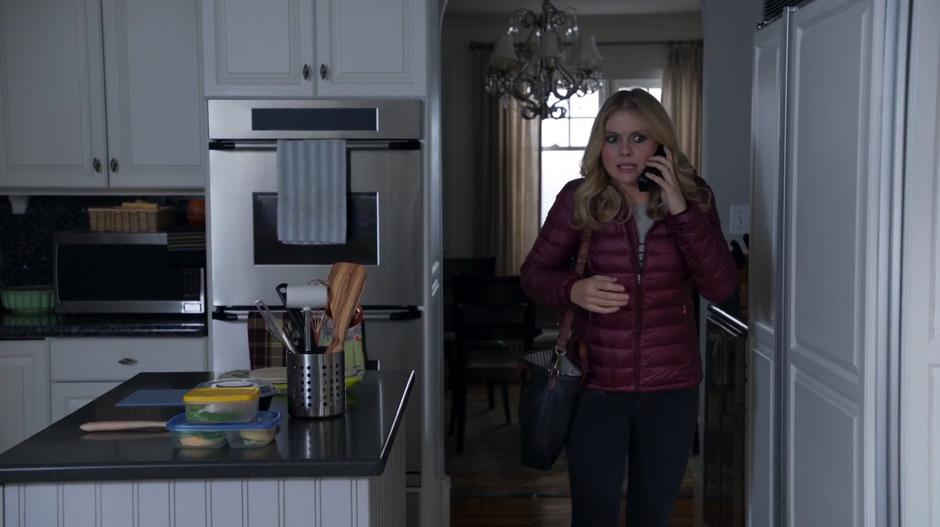 Liv talks to Peyton on the phone in the kitchen to get info on the vaccinations.