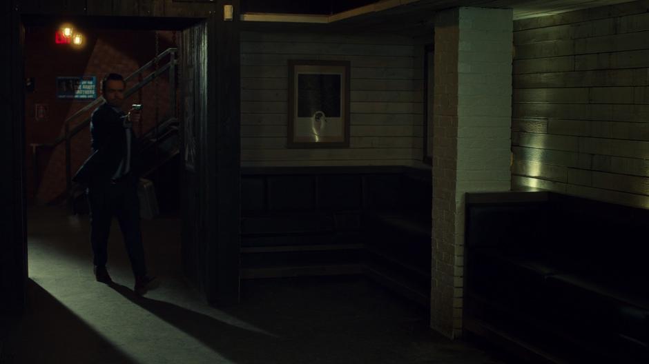 Jaxon points a gun at Waverly and Wynonna in the basement of the club.