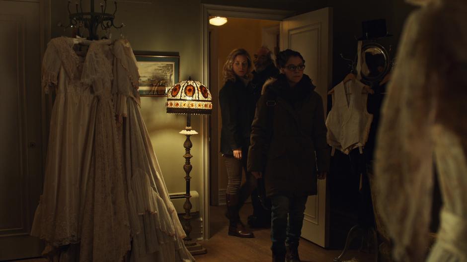 Salvador shows Delphine and Cosima into a room filled with fancy old clothing.
