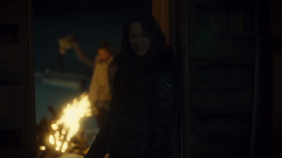 Wynonna smiles at Doc in the barn while Waverly burns Willa's things in the back.