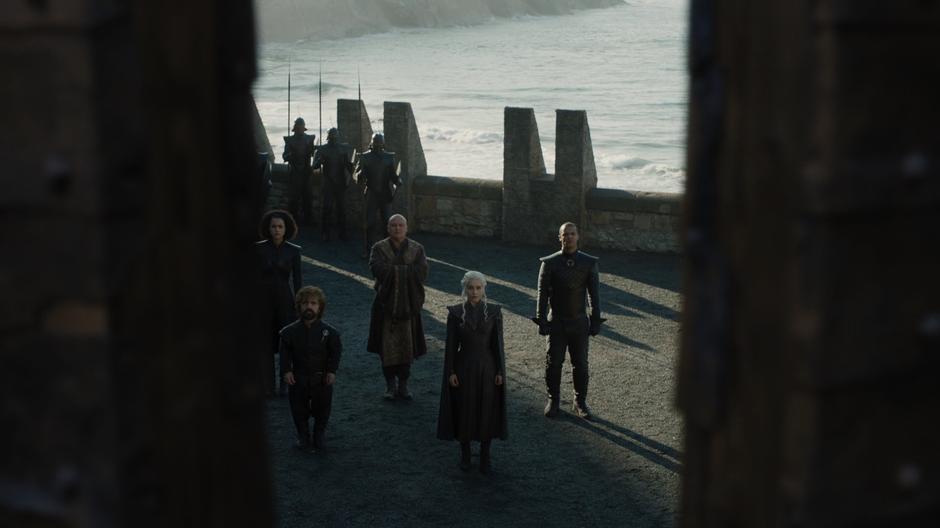 Missandei, Tyrion, Varys, Daenerys, and Grey Worm watch as the gates to Dragonstone open.