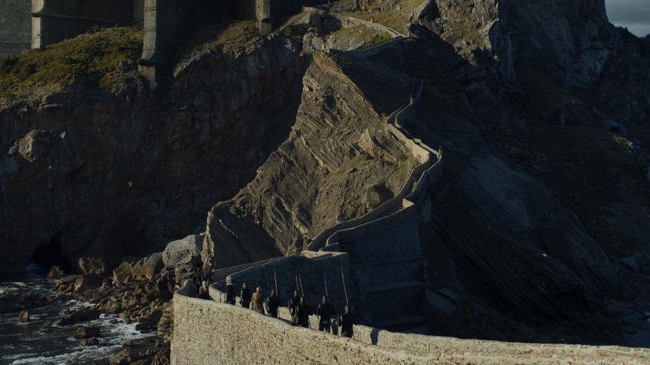 Dany and her entourage continue up the path leading to the castle.