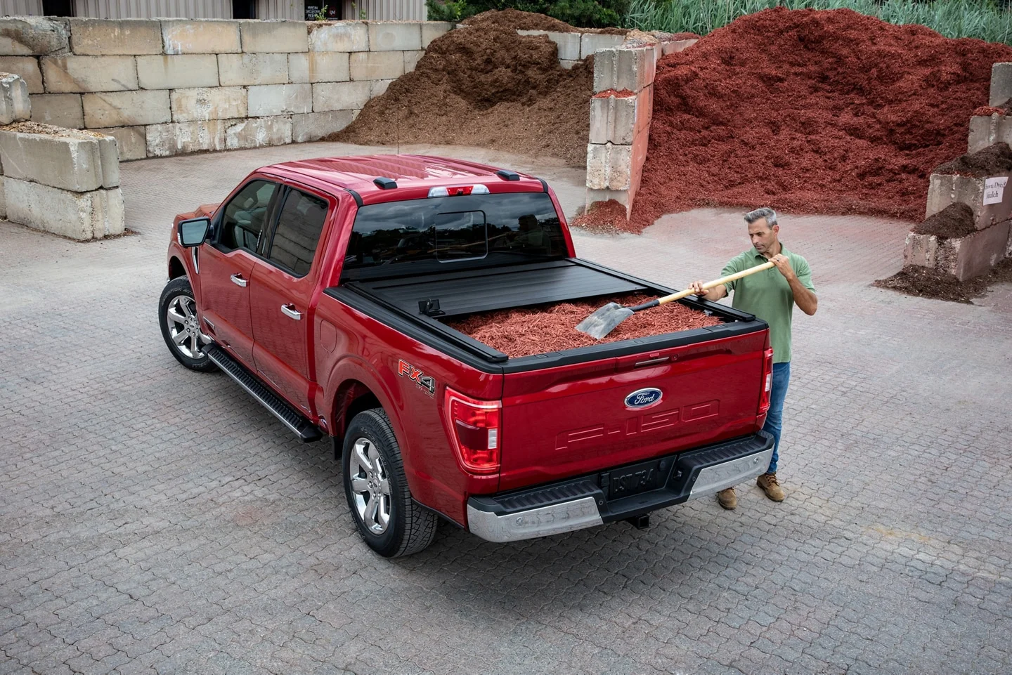 2022 Ford F-150 for sale in Madison, WI Overhead view of a man shoveling mulch into a red F-150