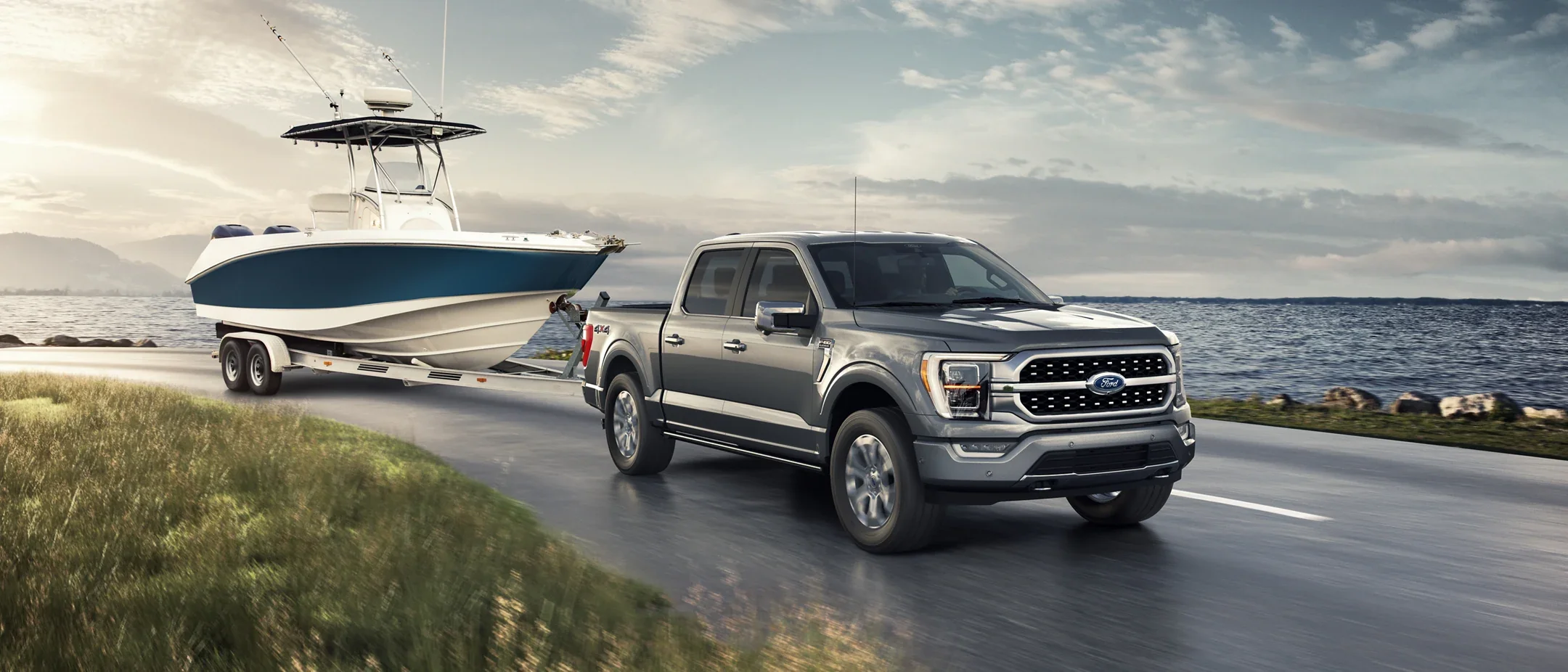 2022 Ford F-150 for sale in Madison, WI Gray F-150 towing a boat by a lake