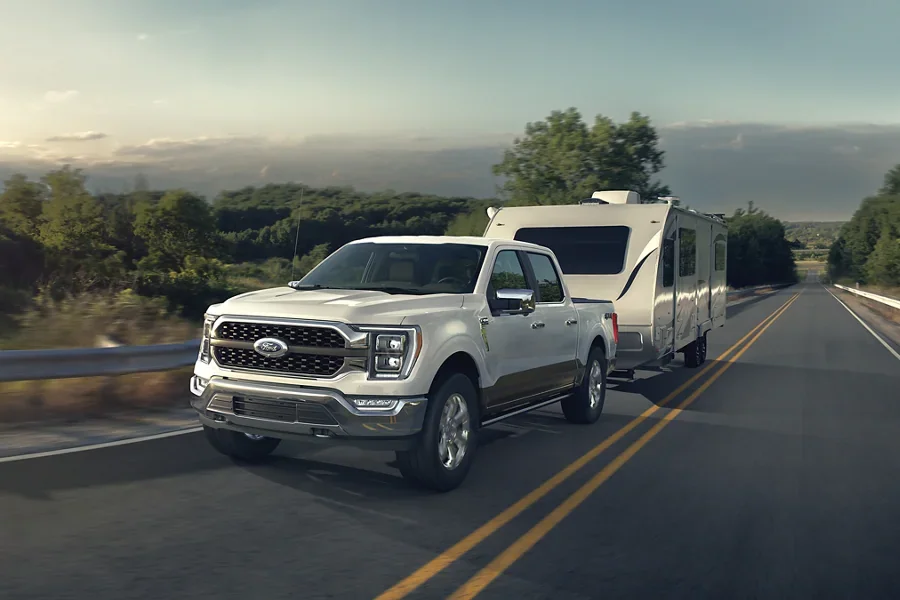 2022 Ford F-150 for sale in Madison, WI White F-150 towing a camper on the highway