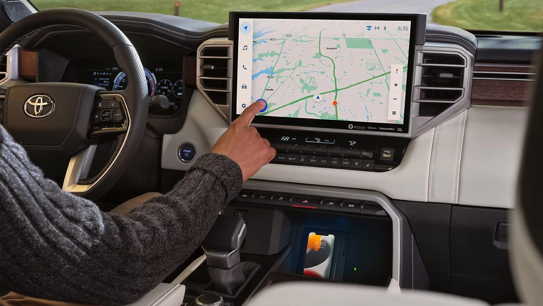 2023 Toyota Sequoia Technology A man using the GPS on the dashboard of a 2023 Toyota Sequoia Capstone