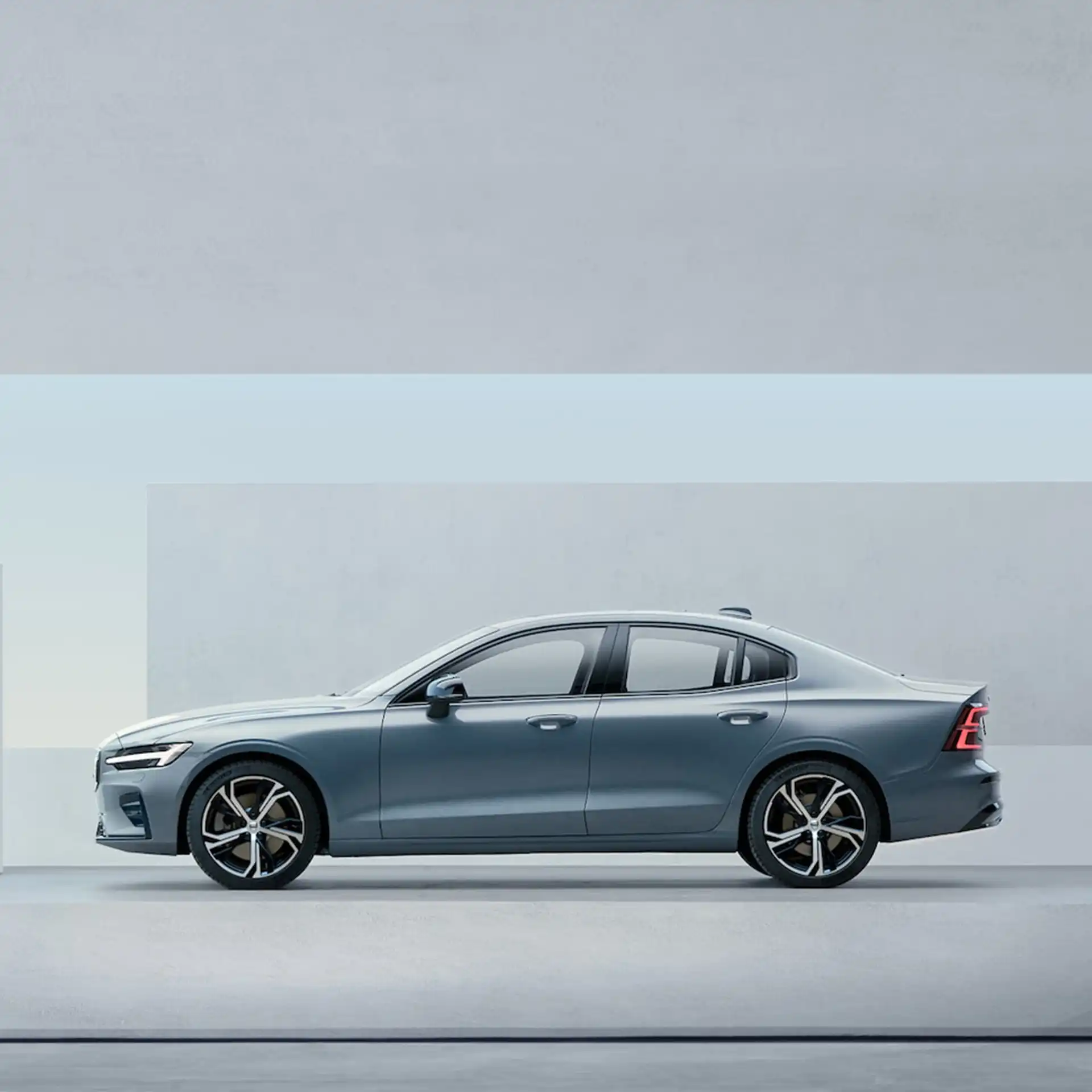 2023 S60 The side profile of a Silver Volvo S60 SUV