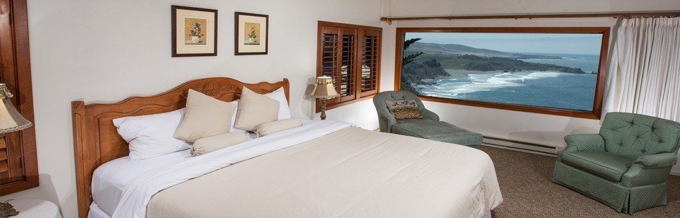 large bed with window overlooking ocean