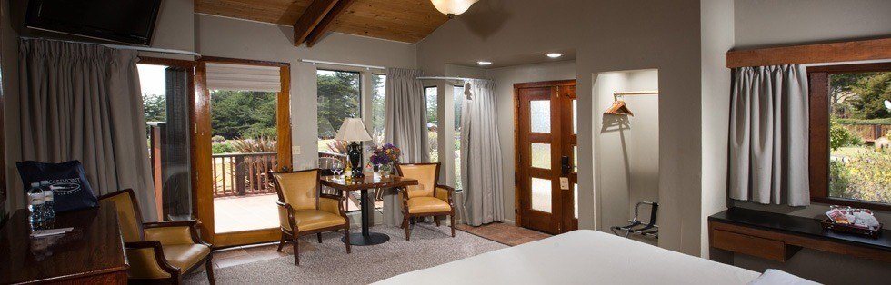 chairs and table near front entrance with windows