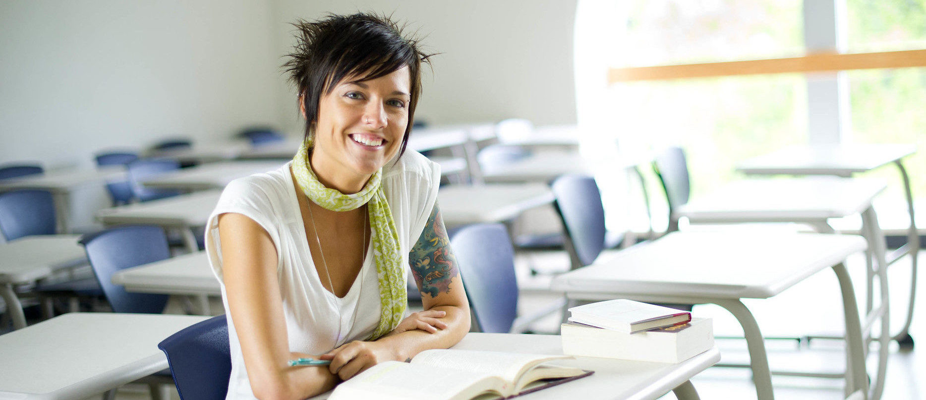 English student studying a book at a desk.