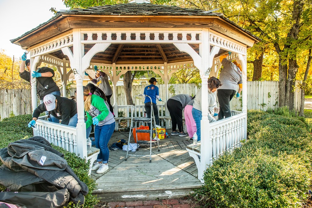 Large group of volunteers maintaining  public facilities.