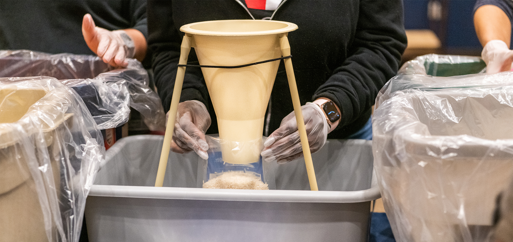 Volunteers preparing food with personal protective equipment.