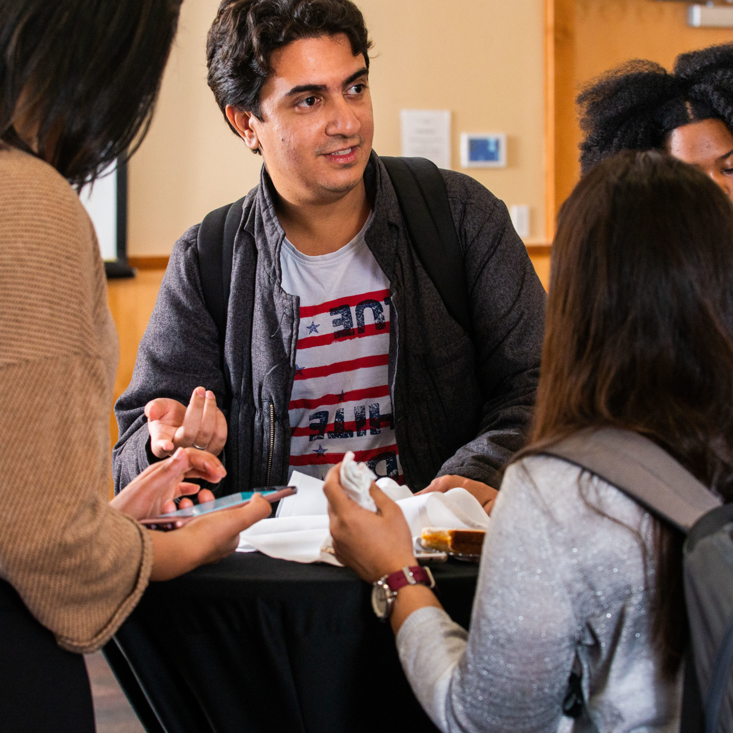 A group of student talking at a table.