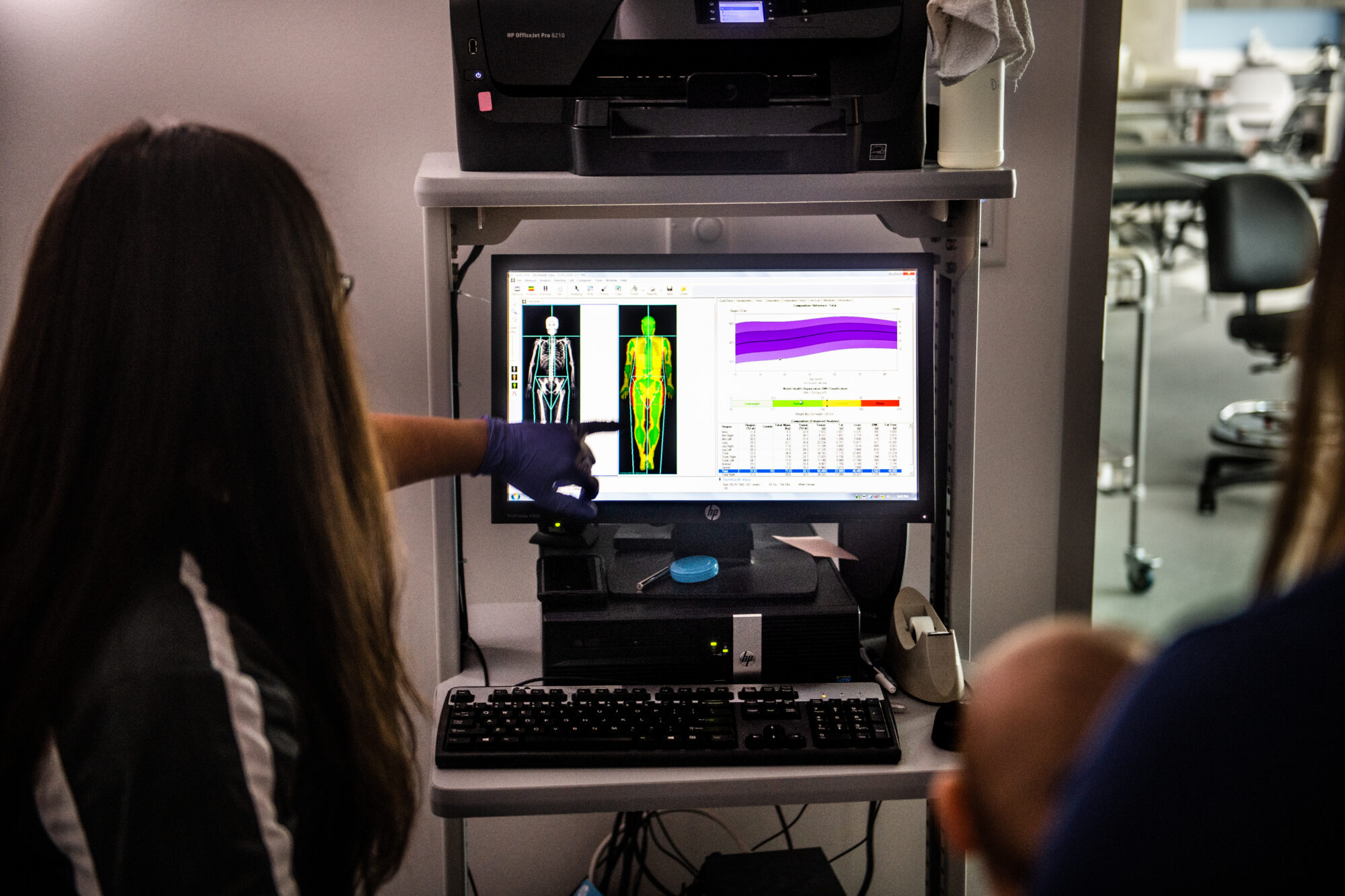 Two nursing students examine medical test results on a computer.