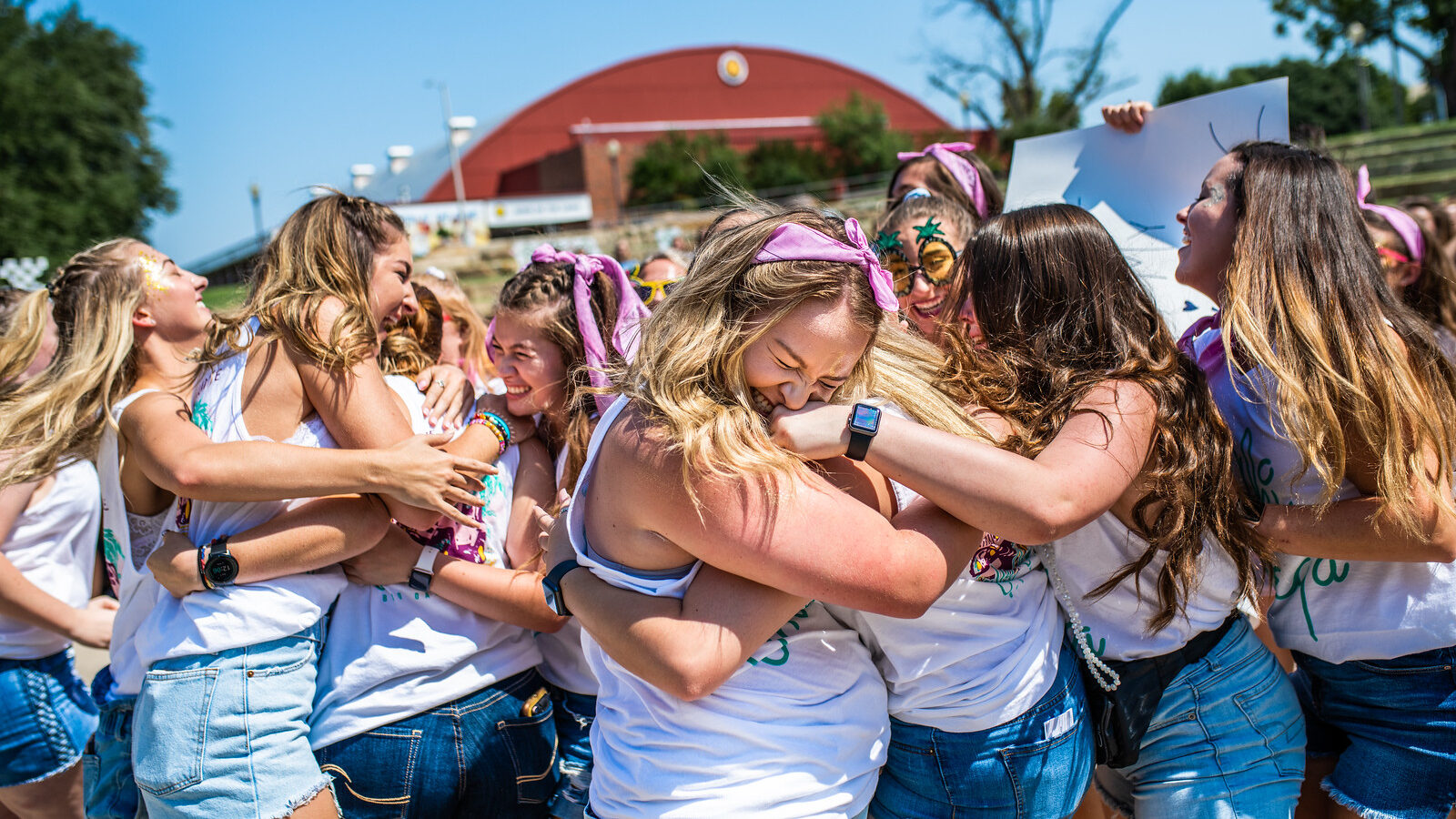 A group of girls from the same sorority celebrating. 
