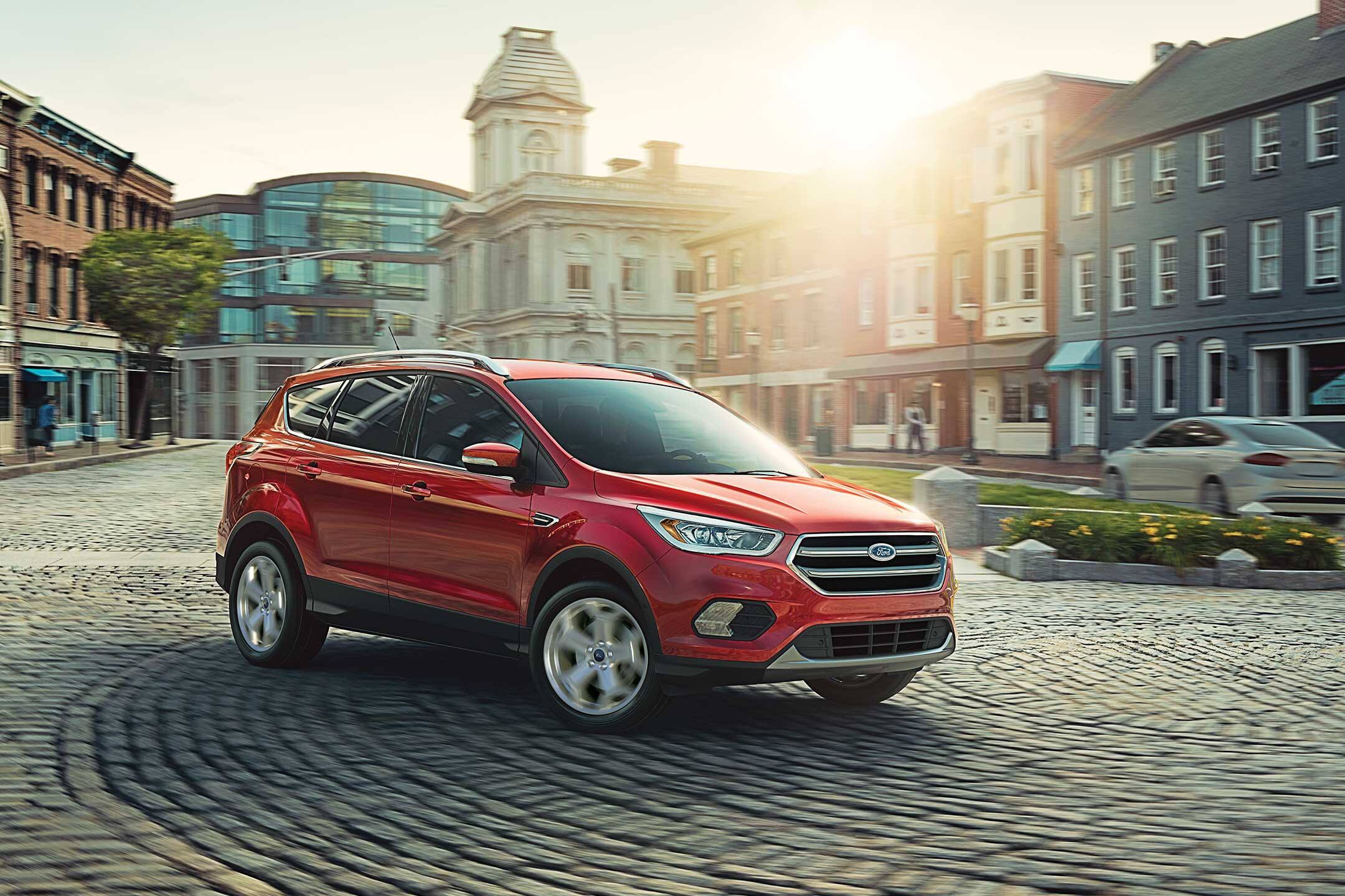 red 2019 ford escape driving through the city