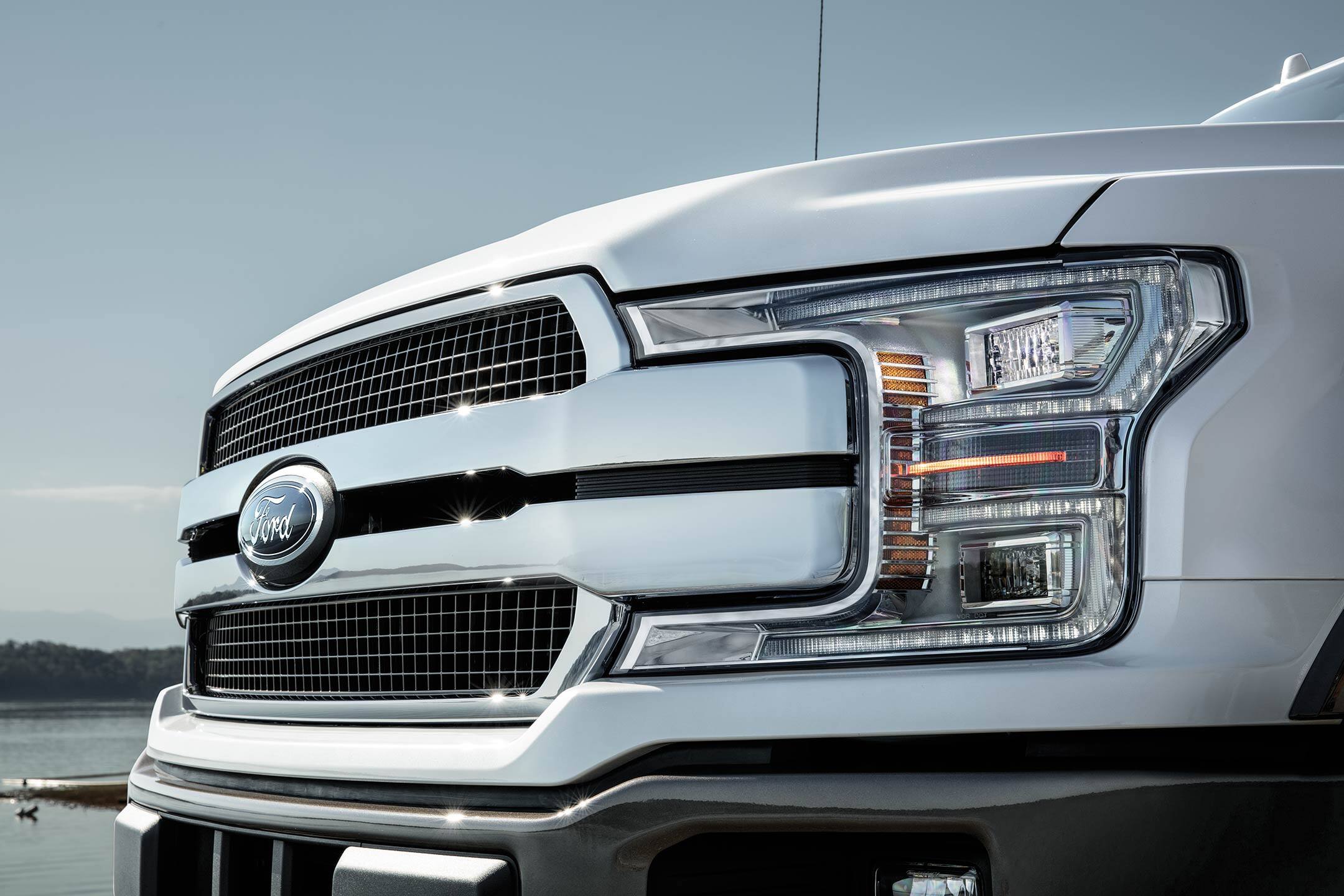 closeup of the headlight of a white 2019 ford f-150