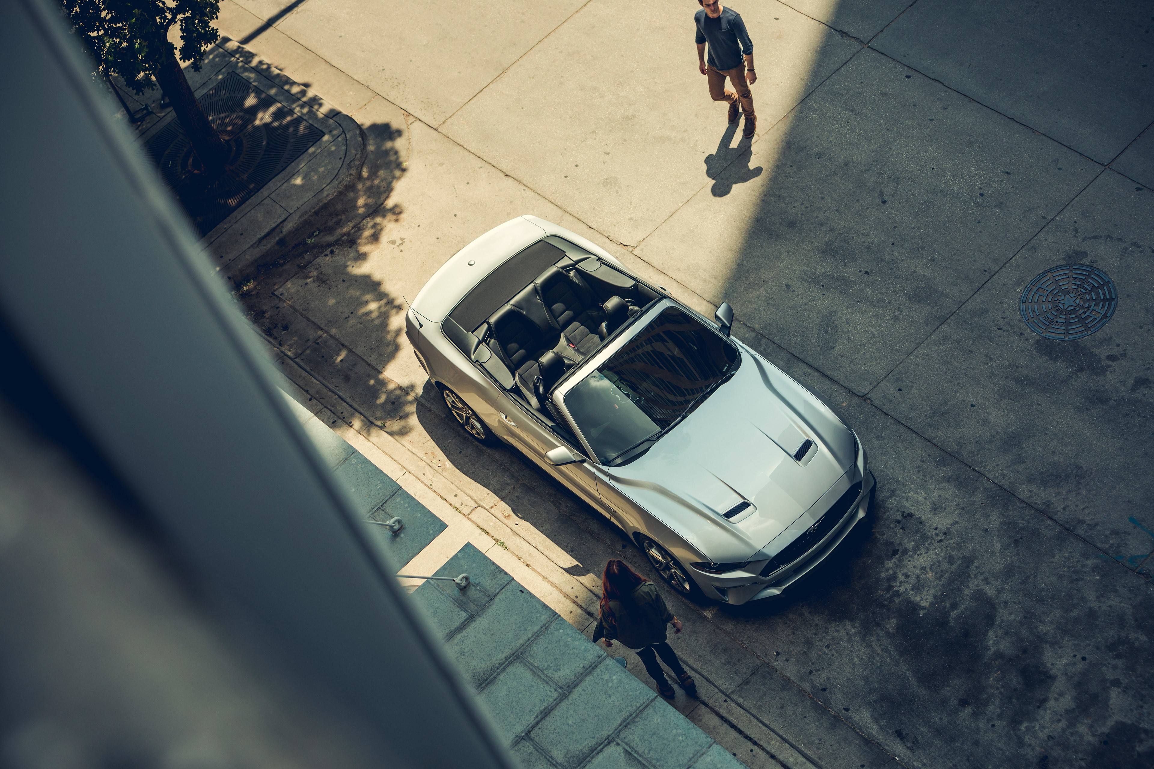 silver 2019 ford mustang convertible parked in front of building