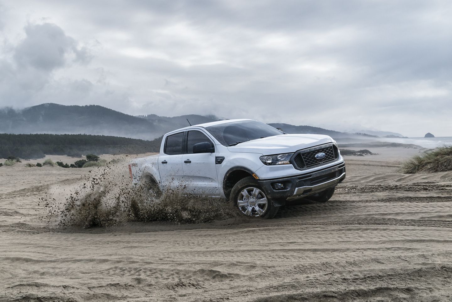white 2019 ford ranger driving through sand