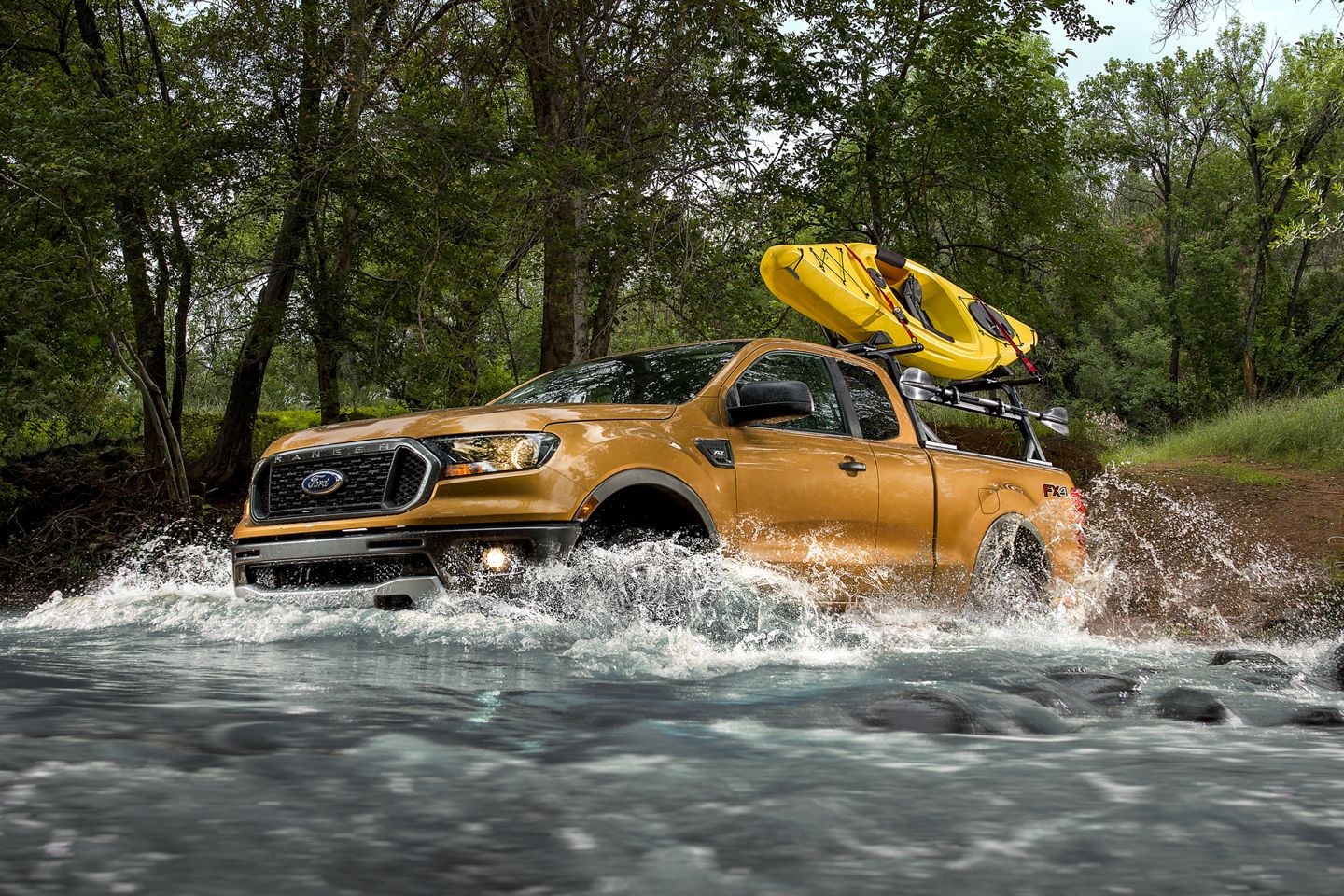 yellow 2019 ford ranger driving through water