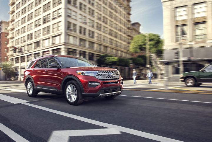 red 2020 ford explorer driving in the city