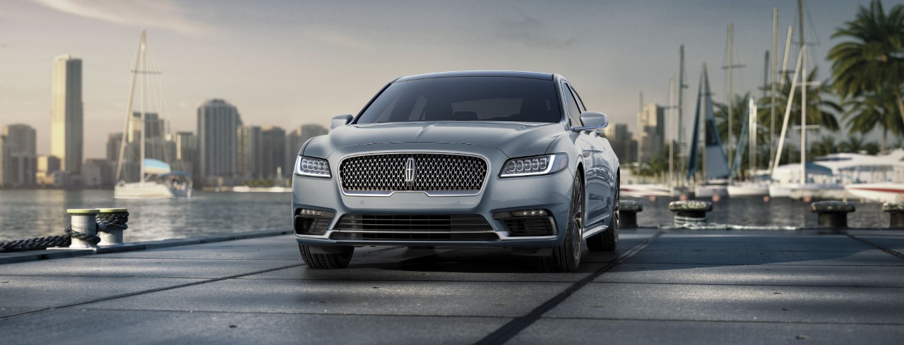 a silver 2019 lincoln continental parked by the water