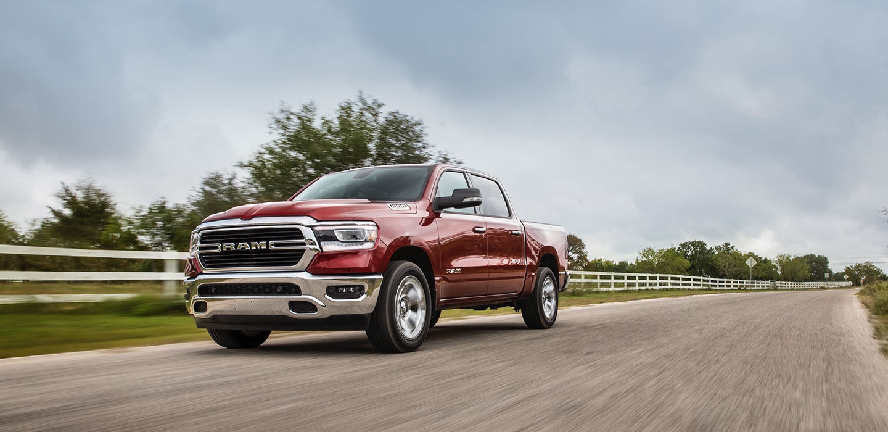 red 2020 ram 1500 driving on a country road
