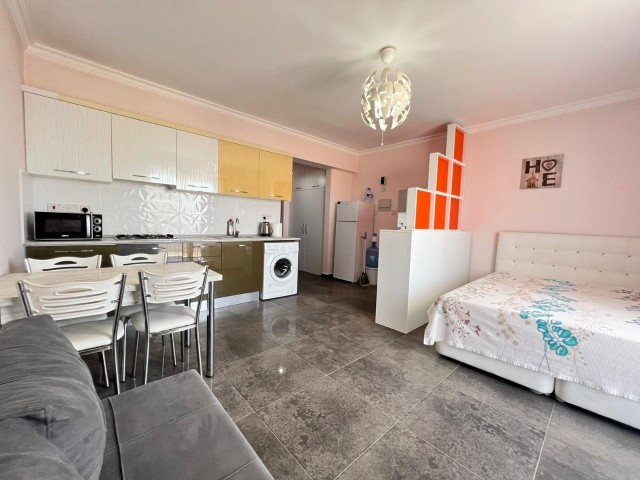 A furnished studio with white goods is for sale in Iskele - Long Beach, RoyalSan Complex. It overlooks the pool.