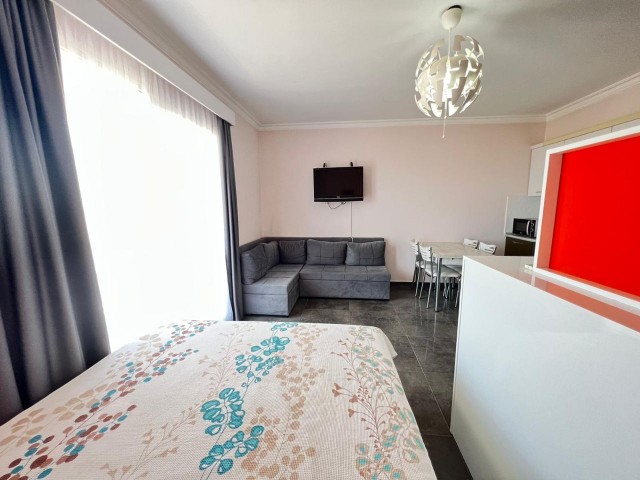 A furnished studio with white goods is for sale in Iskele - Long Beach, RoyalSan Complex. It overlooks the pool.