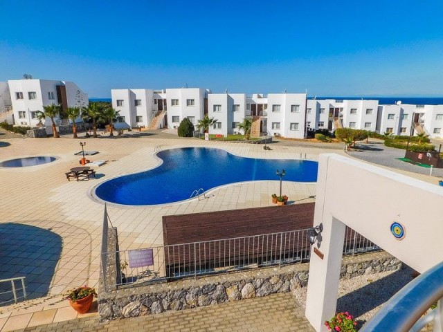 2 bedroom garden resale apartment + fully furnished + communal pools + gated security + Title deed in the owner’s name, VAT paid