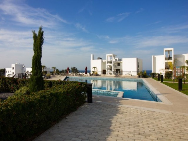 1-bedroom modern garden apartment + fully furnished + communal swimming pool + bar + walking distance to the beach and supermarket + sea and mountain views