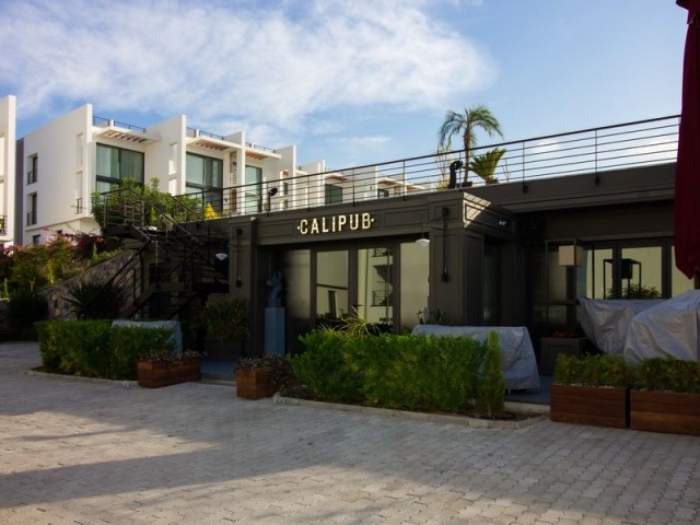 1-bedroom modern garden apartment + fully furnished + communal swimming pool + bar + walking distance to the beach and supermarket + sea and mountain views