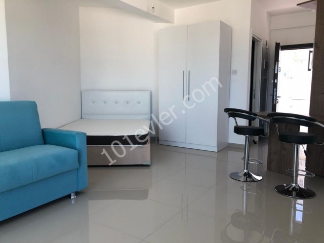 Komplett möbliertes Studio-Apartment zum Verkauf in Alsancak, nur wenige Gehminuten von der Hauptstraße entfernt, mit Gemeinschaftspool und Dachterrasse mit Meerblick.