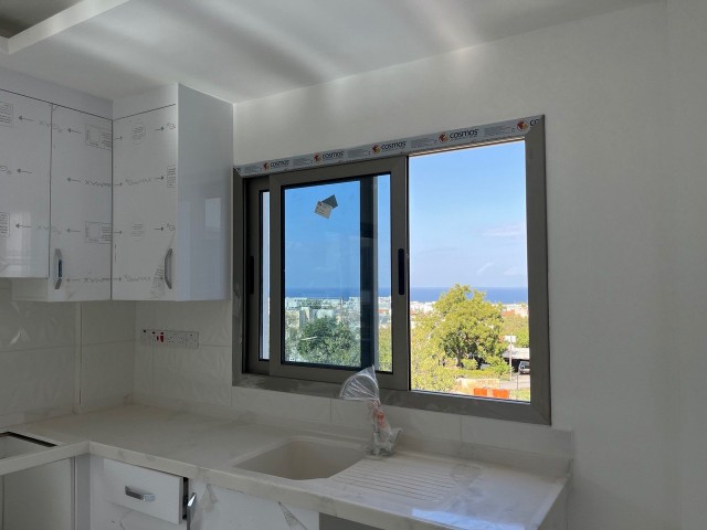 1+1 NEUE WOHNUNG MIT BERG- UND MEERBLICK ZUM VERKAUF IN GIRNE ALSANCAK